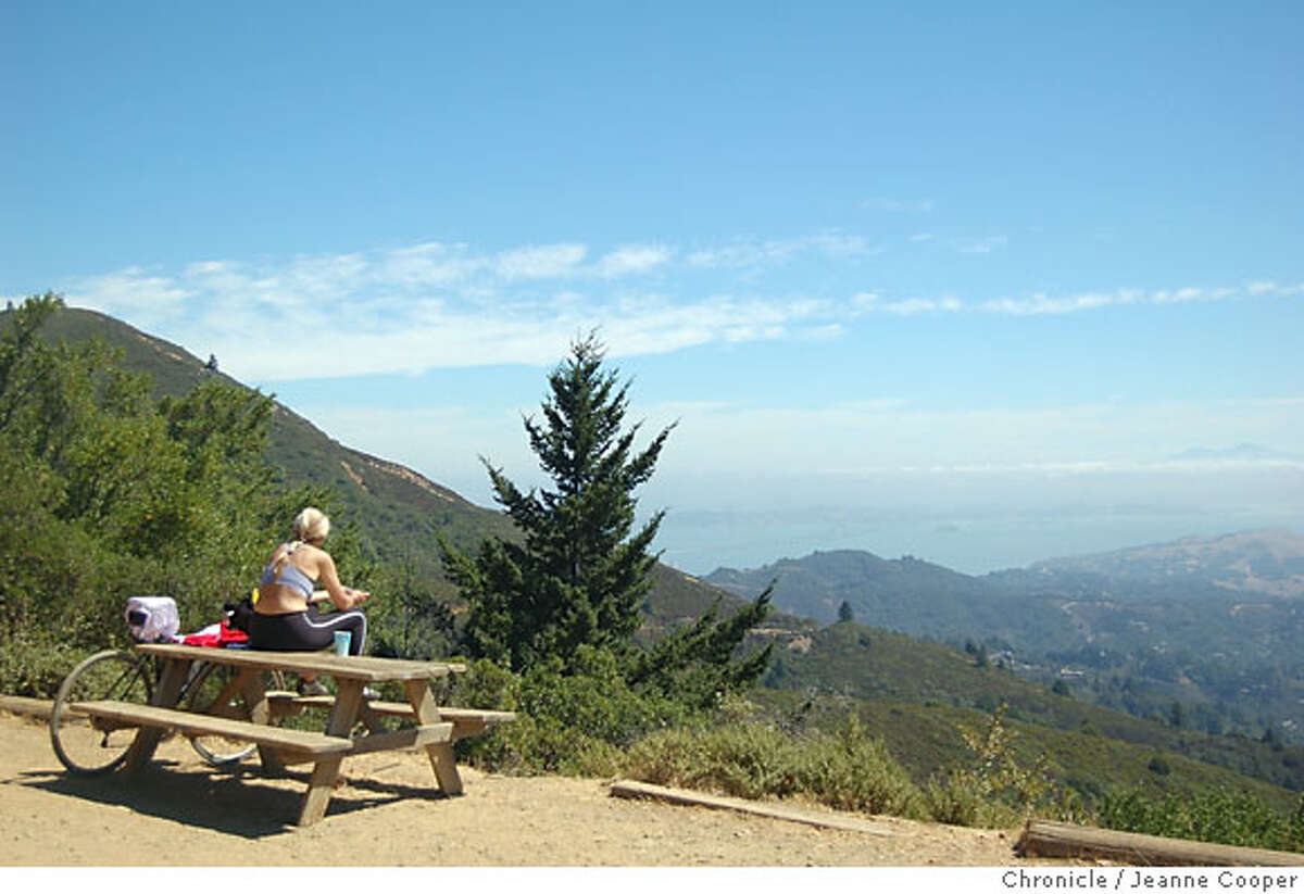TRAVEL MOUNTAIN HOME INN: A mountain biker takes a break at the West Point Inn to gaze at southern Marin and San Francisco Bay. he Photo: Jeanne Cooper / San Francisco Chronicle Sept. 2, 2006