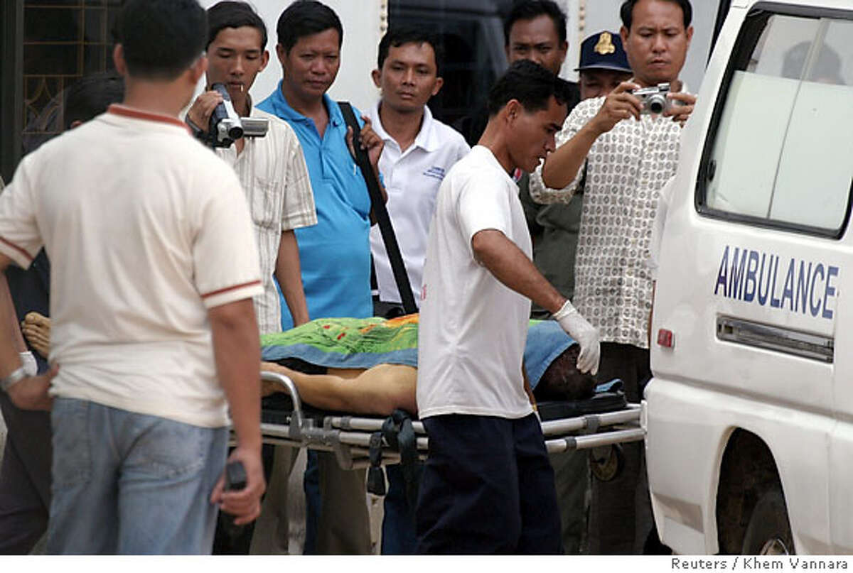 Donald Ramirez's body is brought into an ambulance heading to a hospital inside the anti-human trafficking police facilities in Phnom Penh October 31, 2006. Ramirez, a San Francisco policeman charged last week with sexually assaulting a 14-year-old girl in Cambodia, committed suicide in his jail cell on Tuesday, police said. REUTERS/Khem Vannara (CAMBODIA)