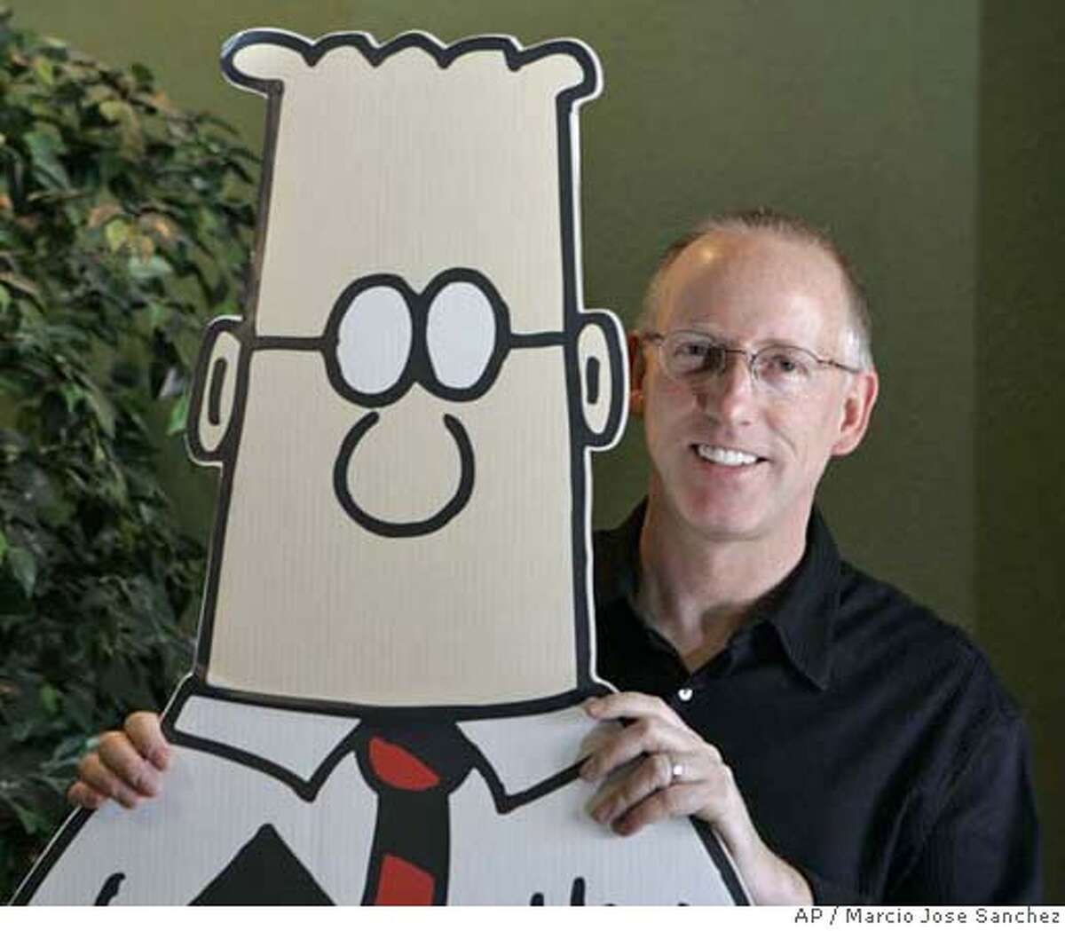 Scott Adams, creator of the comic strip Dilbert, poses for a portrait with the Dilbert character in his studio in Dublin, Calif., Thursday, Oct. 26, 2006. Adams, 49, appears to be a rare example of someone who has largely but not totally, recovered from Spasmodic Dysphonia, a mysterious disease in which parts of the brain controlling speech shut down or go haywire. As many as 30,000 Americans are afflicted, typically in their 40s and 50s, experts say. (AP Photo/Marcio Jose Sanchez)