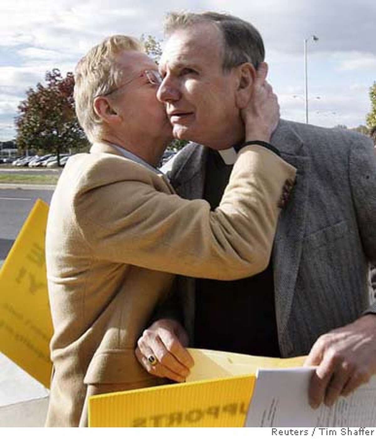Lutheran minister Robert Kreisat (R) is embraced by his partner of 37 years Edward Mather after hearing the New Jersey Supreme court decision on same-sex marriage in front of the Supreme court building in Trenton, New Jersey, October 25, 2006. Saying that times have changed, New Jersey's highest court on Wednesday guaranteed gay couples the same rights as married heterosexual couples but left it to state lawmakers to define how the state wants to define marriage. REUTERS/ Tim Shaffer (UNITED STATES) 0