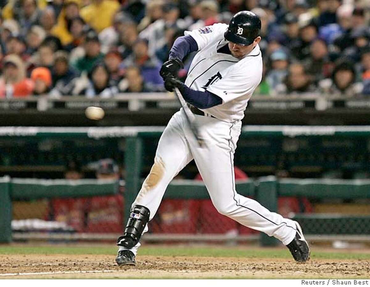 Detroit Tigers Sean Casey hits an RBI single against St. Louis Cardinals in the fifth inning during Game 2 in Major League Baseball's World Series in Detroit October 22, 2006. REUTERS/Shaun Best (UNITED STATES)