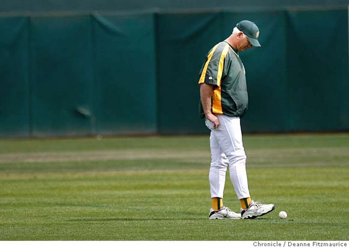 athletics_0423_df.jpg Ken Macha, Oakland Athletics manager, helps round up baseballs from the field after practice. The Oakland Athletics and the Minnesota Twins practiced today on the off day before game three Friday in the Division Series. Event in Oakland on 10/5/06. (Deanne Fitzmaurice/ The Chronicle) Mandatory credit for photographer and San Francisco Chronicle. /Magazines out.