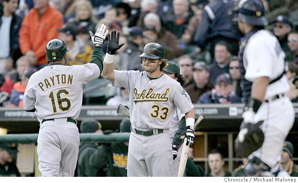 D'Angelo Jiminez gives Nick Swisher of the Oakland Athletics a