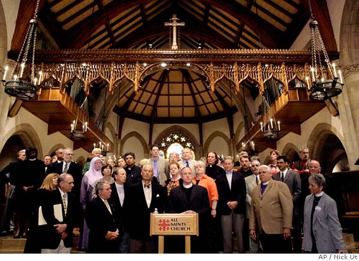 Rev. Edwin Bacon Jr., center, rector of the All Saints Church, speaks during a news conference while surrounded by supporters in Pasadena, Calif., Thursday, Sept. 21, 2006. The church's decision Thursday not to cooperate with an IRS investigation into an anti-war sermon delivered before the 2004 presidential election sets up a high-profile confrontation between the liberal congregation and the IRS, which usually keeps such inquiries private. The leaders of the 3,500-member All Saints Church voted unanimously to resist an order to turn over documents related to the sermon, which was given just two days before the election. The decision means the IRS must decide whether to ask the Justice Department to pursue the case in court. (AP Photo/Nick Ut)