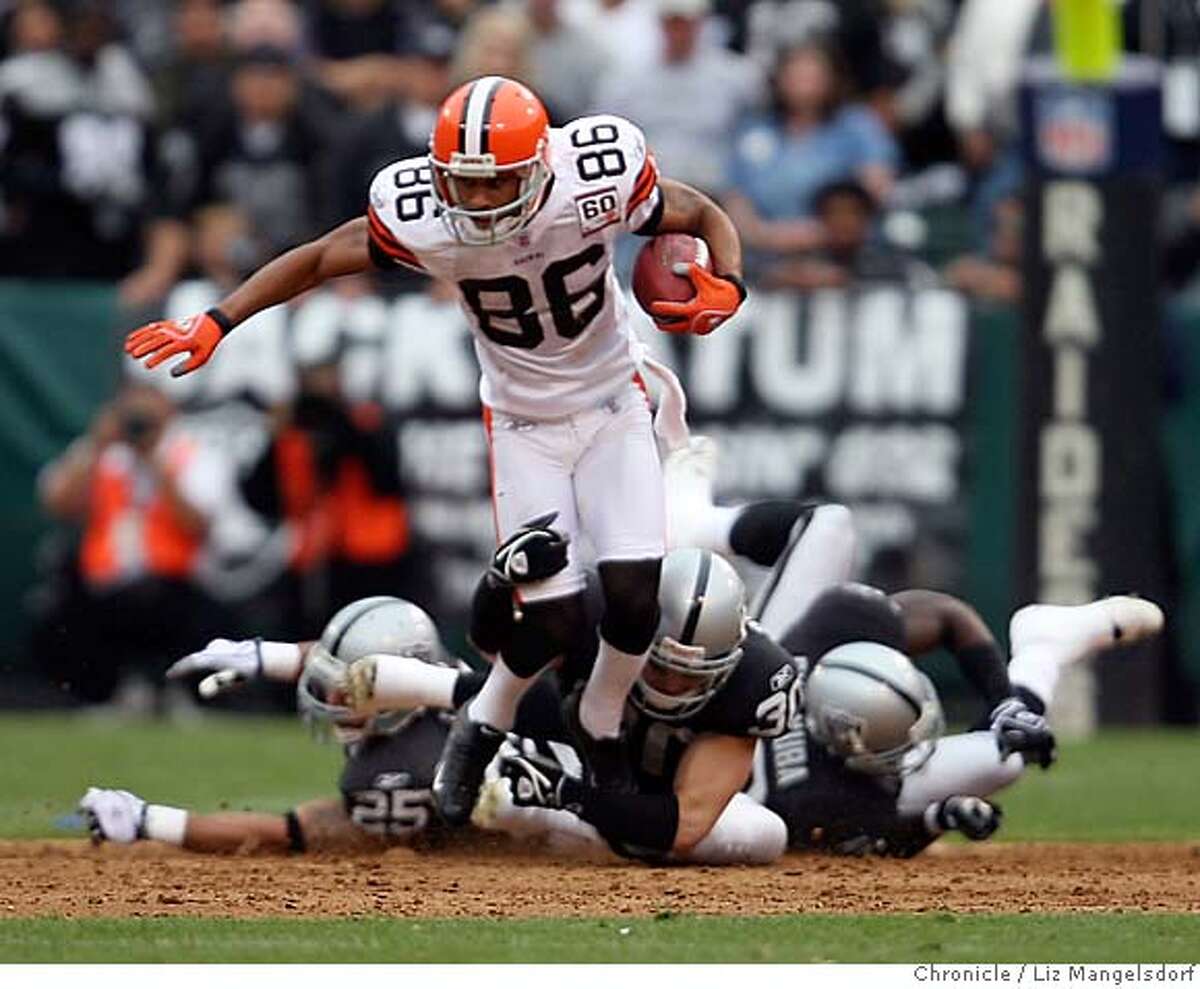 Oakland Raiders kicker Sebastian Janikowski trips up Cleveland Browns wide  receiver Joshua Cribbs (16) in the 2nd quarter, saving a TD. Oakland Raiders  play the Cleveland Browns at McAfee Coliseum in Oakland