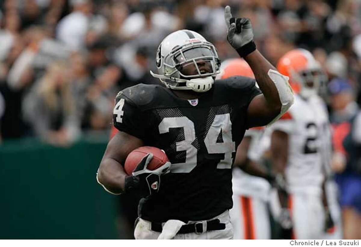 Oakland Raiders Nnamdi Asomugha (21) is all smile after intercepting a pass  by Cleveland Browns QB Charlie Frye intended for Braylon Edwards in the  first quarter at McAfee Coliseum in Oakland, California