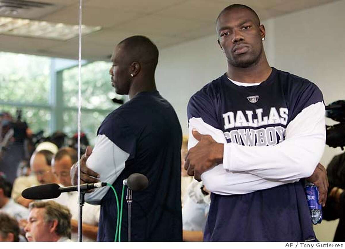 Dallas Cowboys' Terrell Owens stands by as his publicist talks with reporters during a news conference at the Cowboys training facility in Irving, Texas, Wednesday, Sept. 27, 2006. (AP Photo/Tony Gutierrez)