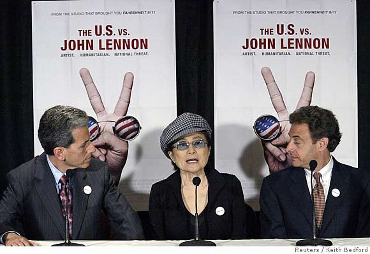 Film makers David Leaf (L) and John Schenfeld (R) listen as Yoko Ono speaks at a news conference to discuss the documentary film "The U.S. vs. John Lennon" in New York, September 6, 2006. REUTERS/Keith Bedford (UNITED STATES)