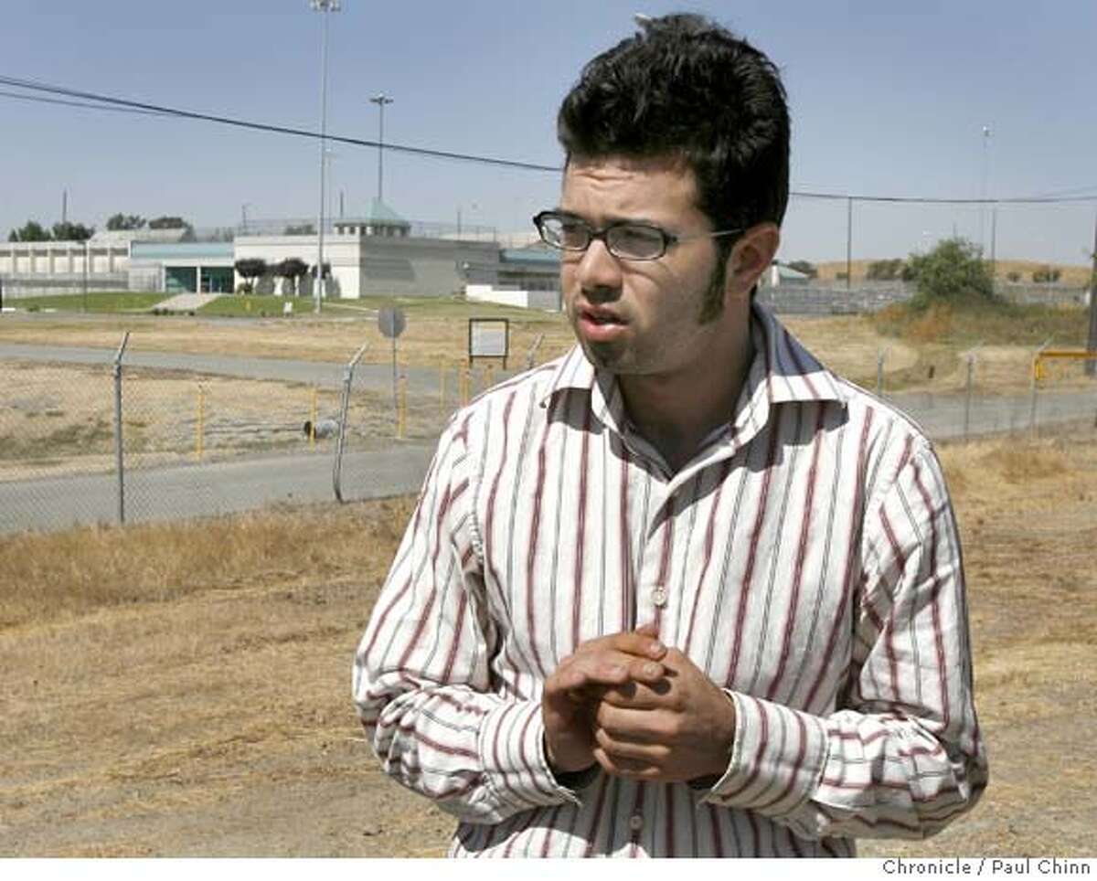 Freelance journalist Josh Wolf speaks to the media before he turns himself in at the Federal Correctional Facility (background) in Dublin, Calif. on Friday, September 22, 2006. Wolf was ordered back to prison by a federal court judge for refusing to hand over videotape footage Wolf shot of a police car being set on fire during a G-8 demonstration. PAUL CHINN/The Chronicle **Josh Wolf
