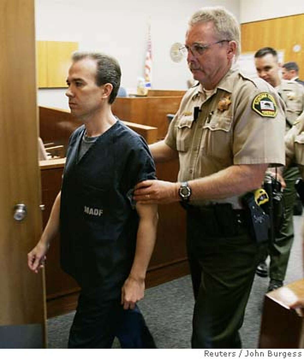 John Mark Karr (L) is taken out of a court room after a bail hearing in Santa Rosa, California, September 19, 2006. Karr, the schoolteacher who made worldwide headlines by confessing to one of America's most notorious unsolved crimes, the murder of six-year-old JonBenet Ramsey, is now facing charges of five counts of possessing child pornography.REUTERS/John Burgess/Pool (UNITED STATES)