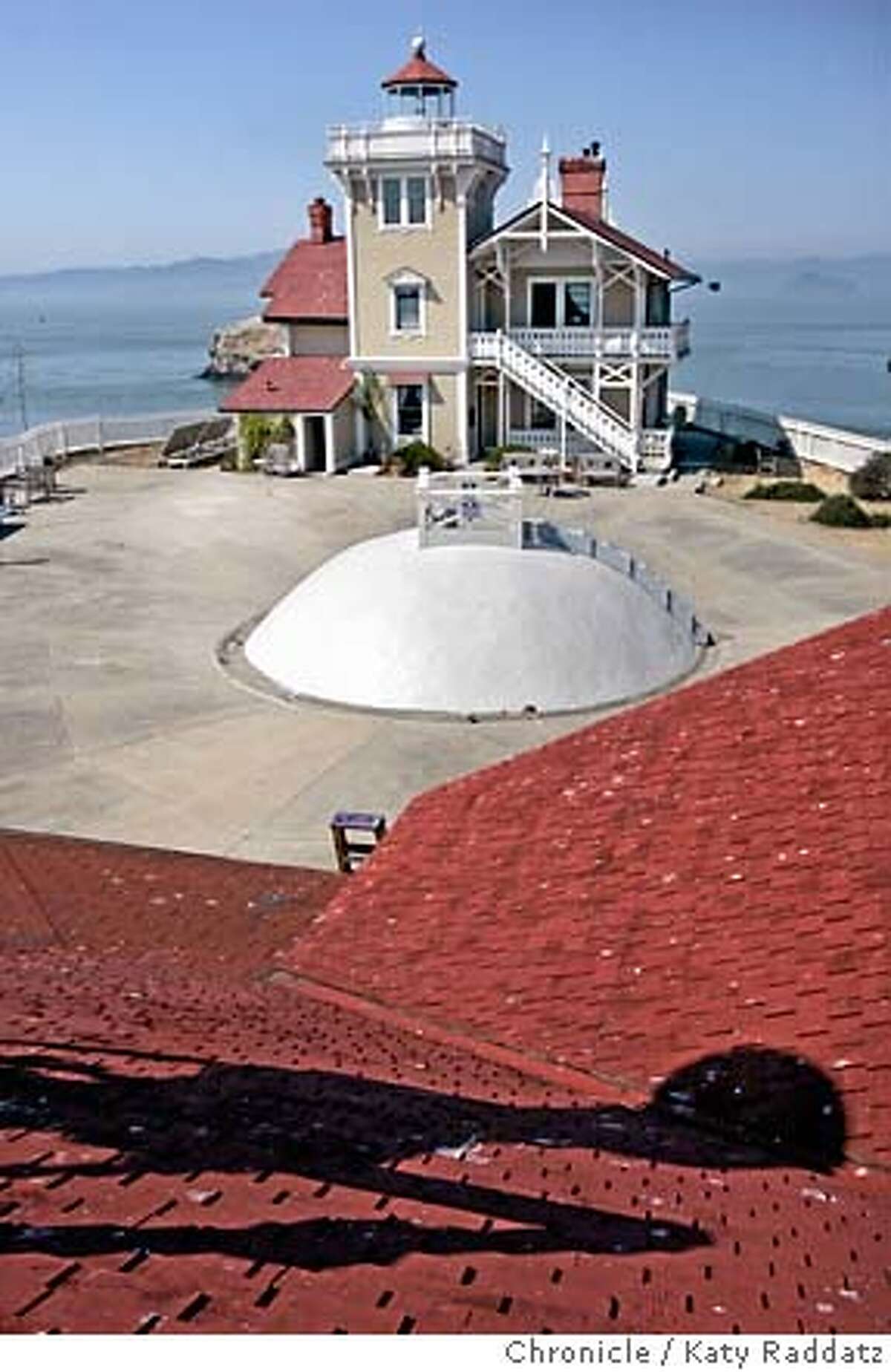 File - The view of the inn and the cistern (the dome) from the roof of the Walter Fanning Fog Signal Building, with the shadow of the southern fog horn on said roof. 