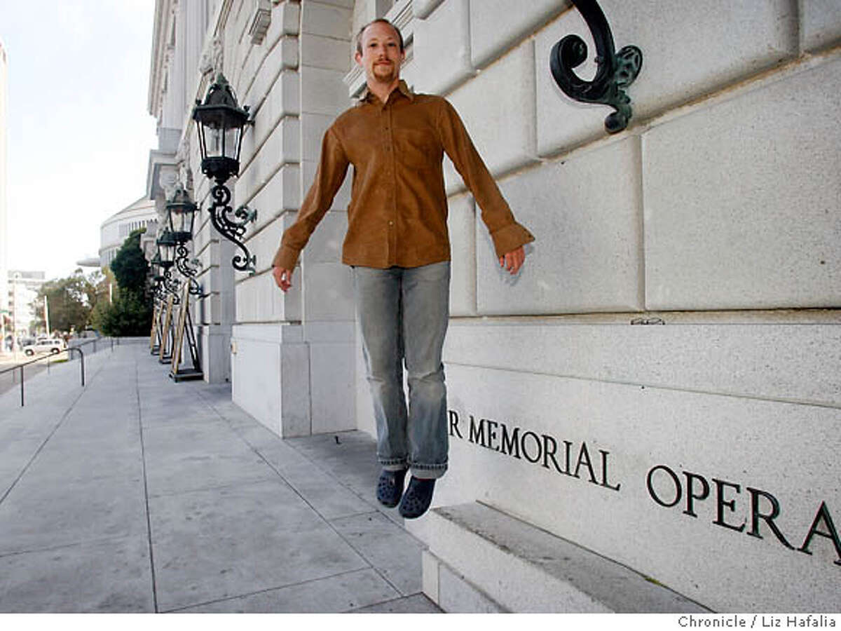 Former intern Justin Taylor gets the jump on the San Francisco Opera season in front of the War Memorial Opera House. Chronicle photo by Liz Hafalia