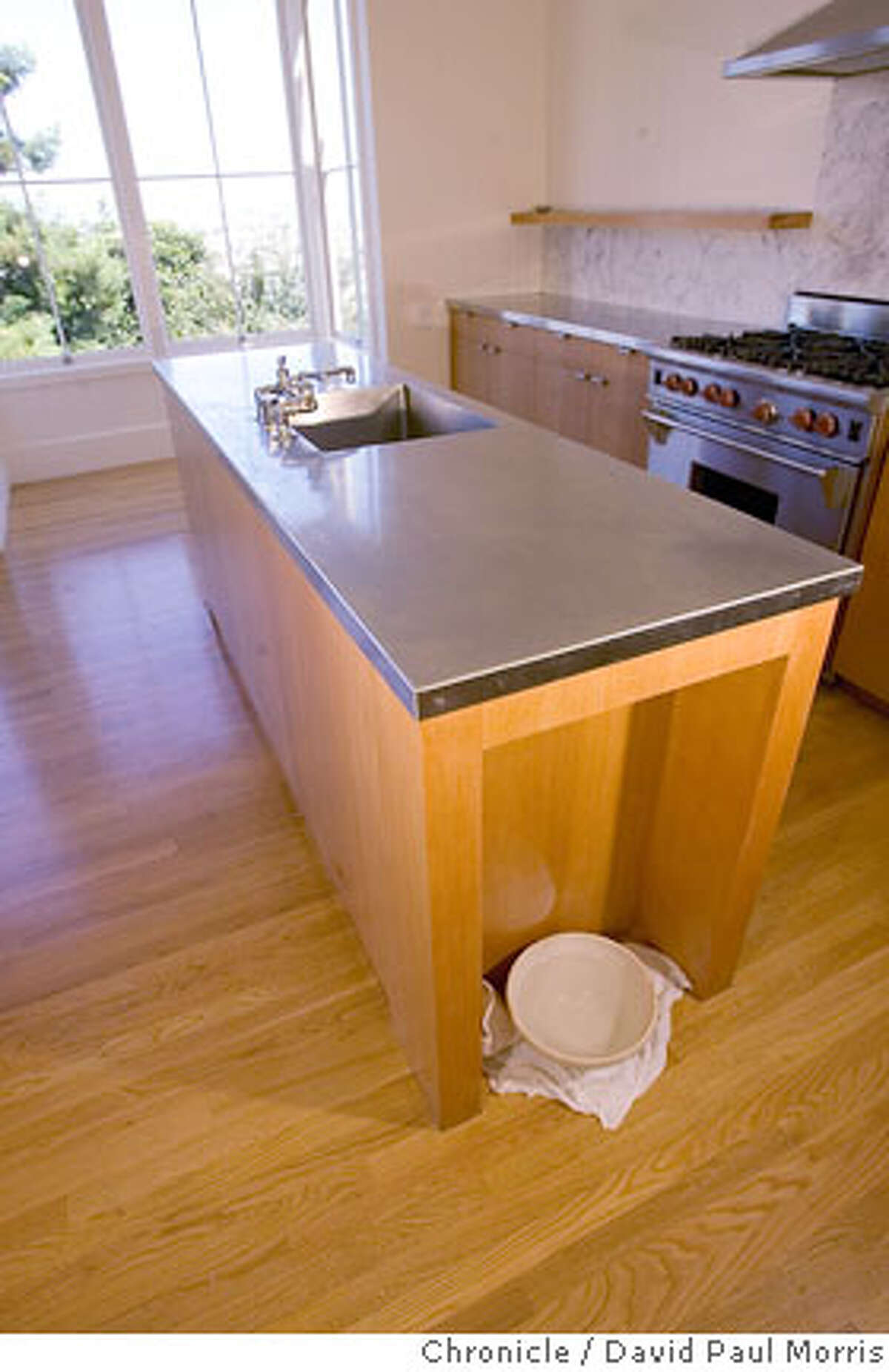 SAN FRANCISCO, CA - JULY 31 The kitchen island recess with dog bowl inside the former home of Malcolm Davis on July 31, 2006 in San Francisco, California. (Photo by David Paul Morris/ The Chronicle) Ran on: 08-27-2006 Left: the hidden cubby for Ace the wonder dog at Jeff Kings house; below, a kitchen island recess with dog bowl in Malcolm Davis home.