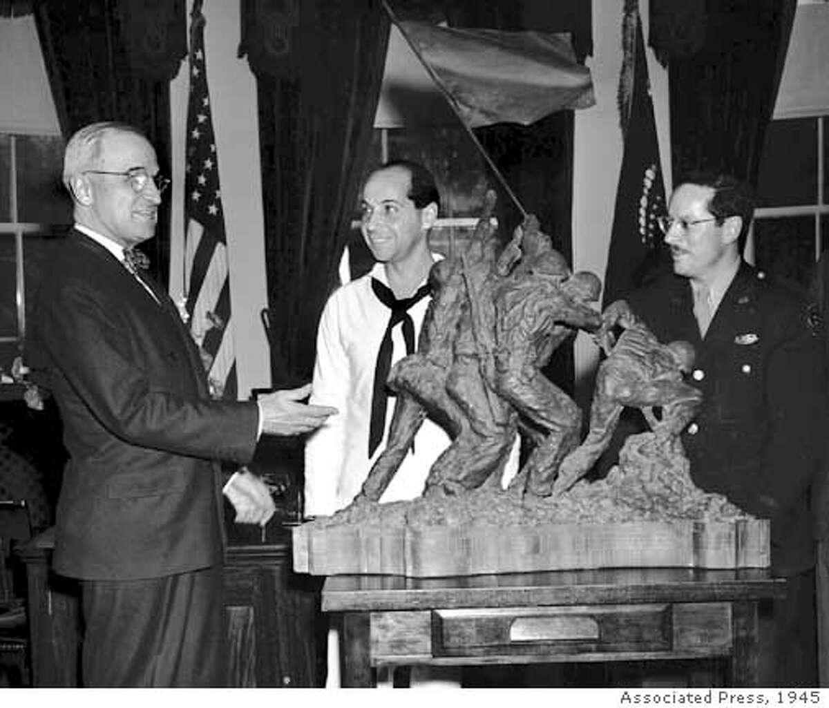 ** FILE ** President Truman is presented with a bronze statue modelled after Associated Press photographer Joe Rosenthal's photo of US marines raising the American flag on Mt. Suribachi, Iwo Jima, at the White House, in this June 4, 1945 file photo. From left, Truman, statue sculptor Felix de Weldon, and AP photographer Joe Rosenthal. De Weldon died Tuesday June 3, 2003 of natural causes. He was 96. (AP Photo/File)