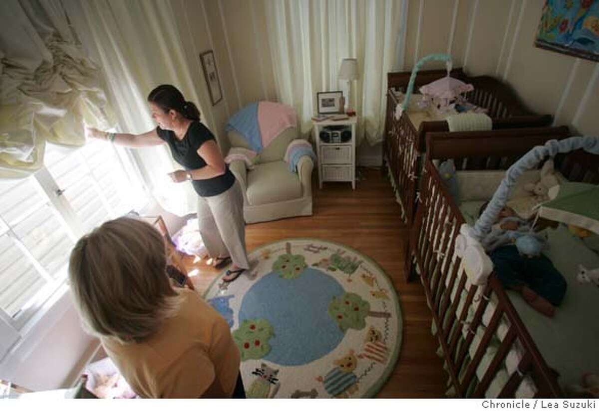 outsource_049_ls.JPG From left: Karen Kesti, sleep trainer; Jeanine Donohue; Liam Donohue (in crib). Jeanine Donohue pulls down the black out curtains in the twins' room after putting Liam in his crib for his second nap of the day. Sleep trainer Karen Kesti, who is revisiting 7month old twins, Liam and Clair and mom is Jeanine Donohue Wednesday, August 9, 2006. Photo by Lea Suzuki/The San Francisco Chronicle Photo taken on 8/9/06, in San Francisco, CA. **(themselves) cq. MANDATORY CREDIT FOR PHOTOG AND SAN FRANCISCO CHRONICLE/ -MAGS OUT