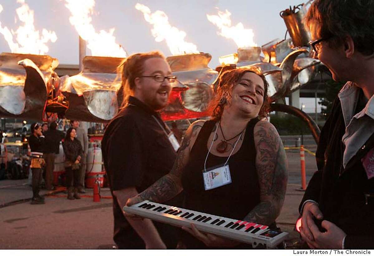 Tasha Berg lets out a laugh after using the piano keys to control the fire coming out of the Flaming Lotus Girl's "The Serpent Mother" sculpture at the Crucible Fire Arts Festival in Oakland, CA. Berg is a member of the Flaming Lotus Girls and was one of the members who came up with the original concept for the sculpture. Laura Morton/The Chronicle Ran on: 08-20-2006 Tasha Berg belts out a laugh after using piano keys to control the fire of the Flaming Lotus Girls creation The Serpent Mother at the Crucible Fire Arts Festival in Oakland recently. Ran on: 08-20-2006 Tasha Berg belts out a laugh after using piano keys to control the fire of the Flaming Lotus Girls creation The Serpent Mother at the Crucible Fire Arts Festival in Oakland recently.