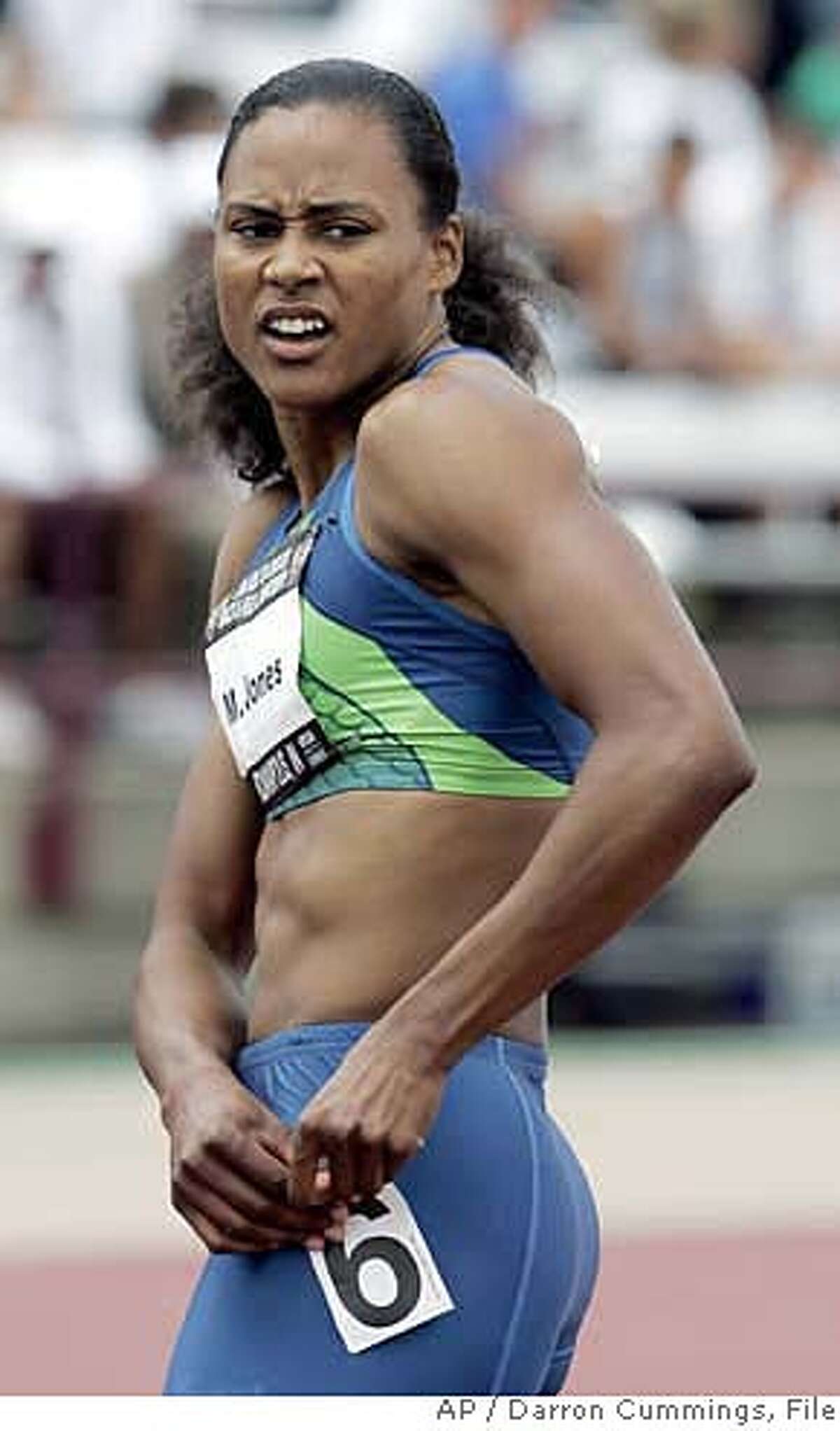 Marion Jones takes a look at her time of 11.17 in the prelims of the women's 100 meter run during the U.S. Outdoor Track & Filed Championships in Indianapolis, Friday, June 23, 2006. (AP Photo/Darron Cummings)