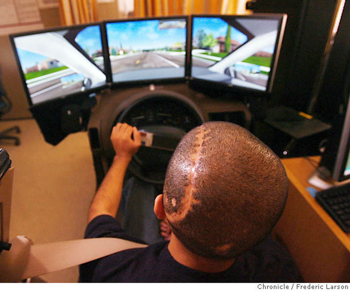 Angel Gomez (20) a Marine vet wounded in Iraq works with Max Gray on a driver training simulator which gauges brain damage in veterans (like Angel)injured in the war in Iraq at the brain trauma center at the Palo Alto Veterans Administration Hospital. ***Angel Gomez 6/27/06 {Frederic Larson/The Chronicle} **Henry Lew Ran on: 08-13-2006 Above: Iraq war vet John Potter in a driver training simulator; right, another vet, Angel Gomez, at the wheel.