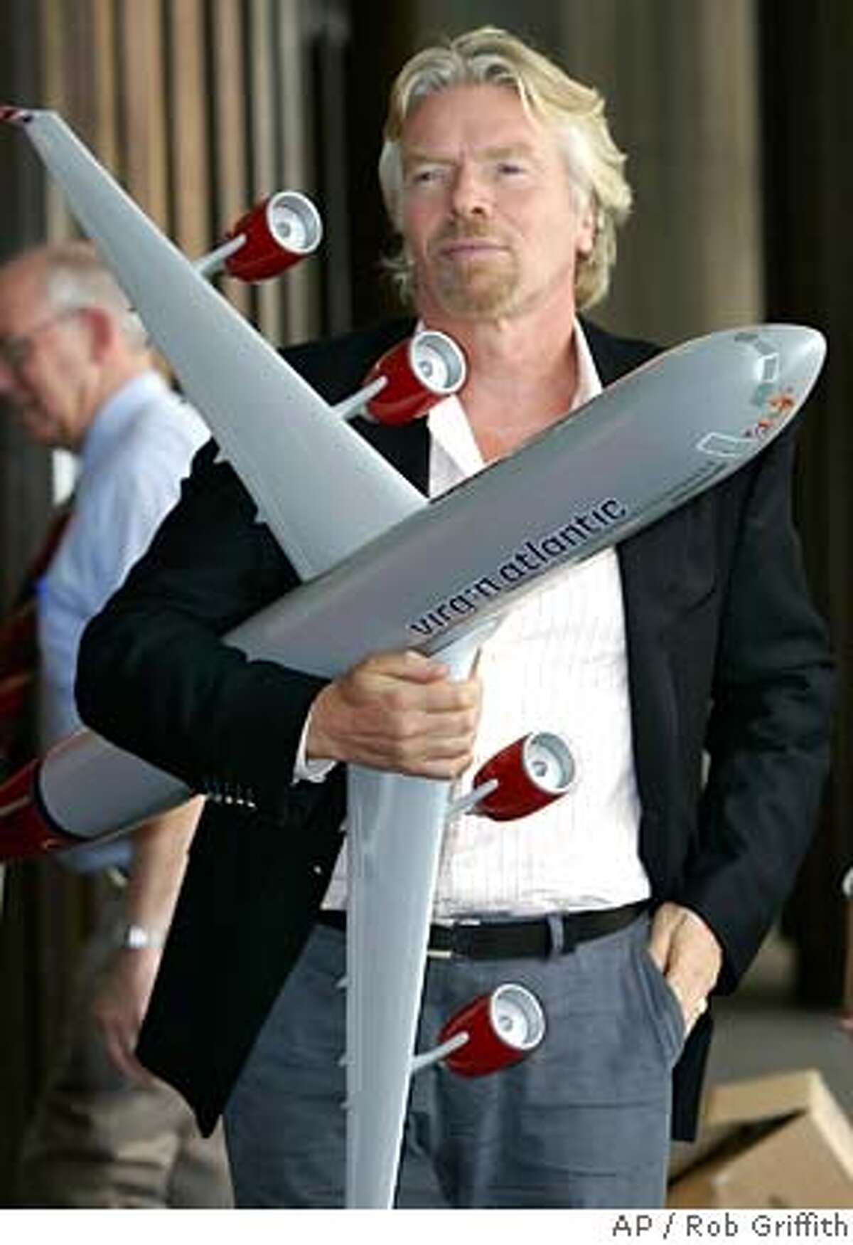 Sir Richard Branson stands outside a hotel in Sydney, Australia, Thursday, Dec. 8, 2005, holding a model Virgin Atlantic plane. Sir Branson is in Australia to celebrate the first-year anniversary of Virgin Atlantic's London-Australia route. (AP Photo/Rob Griffith) Ran on: 12-09-2005 Richard Branson, part owner of the proposed Virgin America airline, says the low-cost carrier should begin flying out of SFO next year.
