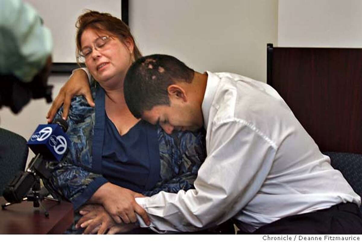 Asa Sullivan's mother, Kathleen Espinosa is comforted by her husband, Nelson Espinosa at a press conference.