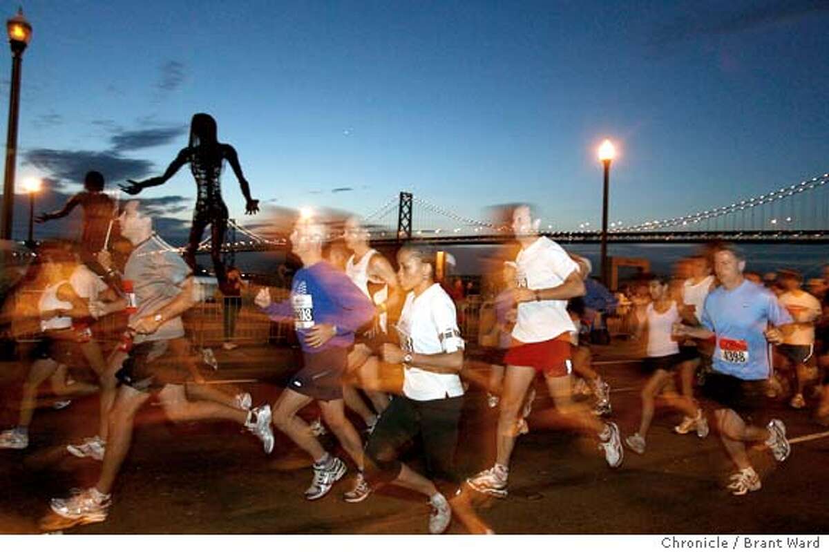 Runners began their trek at the Embarcadero in San Francisco where they first ran past views of the Bay Bridge. Elite runners started at 5:30am. A record 15,000 runners were expected for the San Francisco Marathon Sunday July 30. The 26.2 mile citywide route took the runners through Golden Gate Park and the Golden Gate bridge under perfect conditions for running. {Brant Ward/The Chronicle} 7/29/06