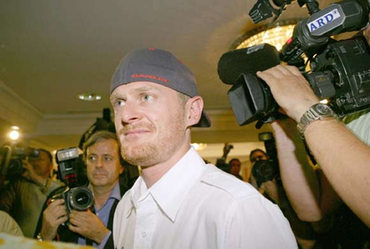Tour de France winner Floyd Landis of the U.S. leaves a news conference in Madrid July 28, 2006. Landis denied committing any doping offence in his first appearance 24 hours after news of his positive test from the race was made known. REUTERS/Paul Hanna (SPAIN) 0