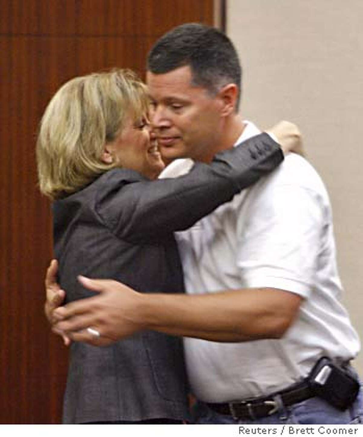 Andrea Yates' ex-husband Russell Yates is hugged by Mary Parnham after the verdict in Andrea Yates murder retrial was read in Houston July 26, 2006. A jury on Wednesday found Andrea Yates not guilty by reason of insanity in the drownings of her five children, ages 6 months to 7 years, in the bathtub of their Houston home five years ago. REUTERS/Brett Coomer / Houston Chronicle/Pool (UNITED STATES)