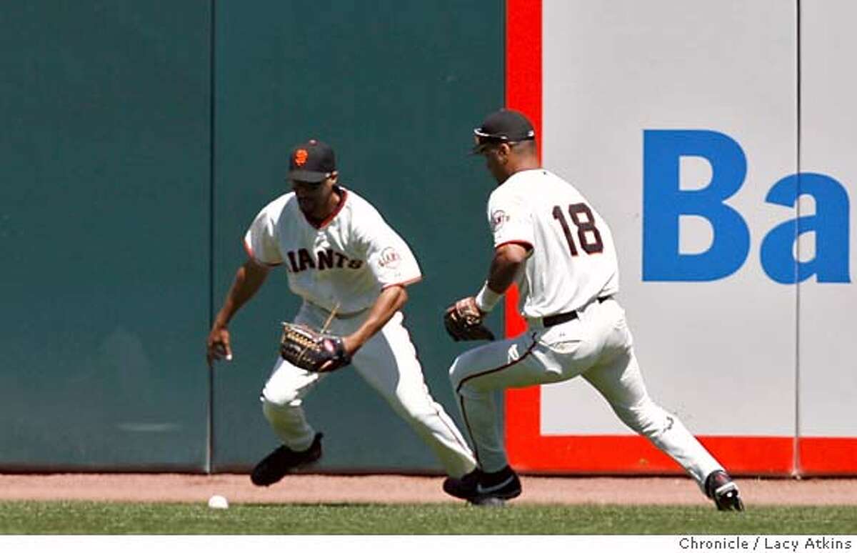 San Francisco Giants Randy Winn and Moises Alou scramble to get the ball from Philadelphis Phillies Chase Utley triple in the eighth inning, Sunday July 16, 2006, in San Francisco, Ca. He was the winning run on Pat Burrell's hit. San Francisco Giants host the Philadelphia Phillies, Sunday July 16, 2006 at AT&T Ballpark in San Francisco, Ca. (Lacy Atkins/The Chronicle) MANDATORY CREDITFOR PHOTGRAPHER AND SAN FRANCISCO CHRONICLE/ -MAGS OUT