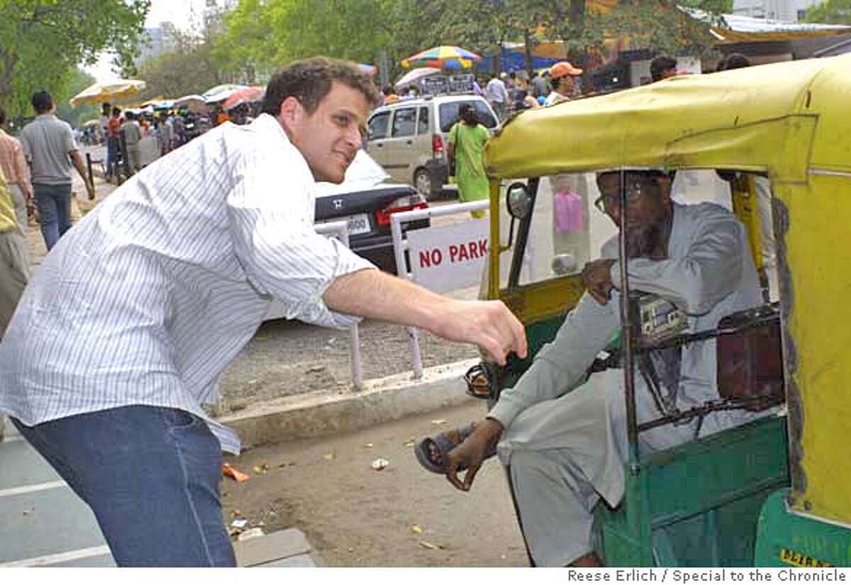 Transport is cheap in India. Here, former California resident Erik Simonsen negotiates a fare with a New Delhi cab driver. Photo by Reese Erlich/Special to The Chronicle