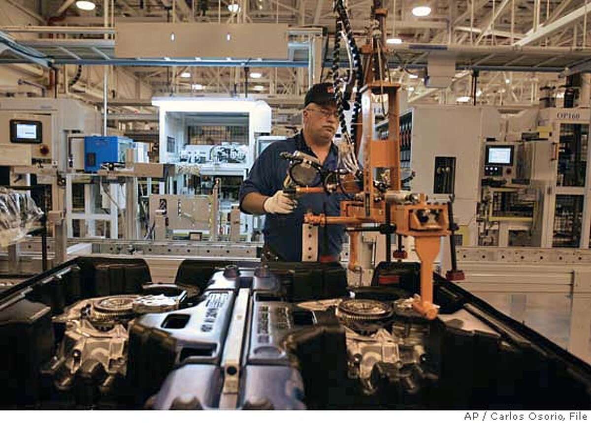 Garry Matties works on the assembly line at the General Motors Powertrain Warren transmission plant in Warren, Mich., Thursday, June 1, 2006. GM Chairman and CEO Rick Wagoner announced that the company will spend $332 million to expand its Warren transmission plant. The investment will allow the Macomb County factory to produce front-wheel-drive automatic transmissions for the 2007 Pontiac G6, the new 2007 Saturn Aura and three new crossover vehicles: the Saturn Outlook, GMC Arcadia and Buick Enclave. (AP Photo/Carlos Osorio)