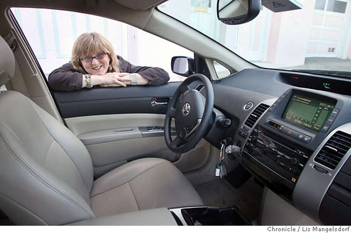 Marian Keeler peers into her Prius hybrid. For all its popularity, the car's interior environment makes the author wish a clean green car is around the corner. Chronicle photo by Liz Mangelsdorf
