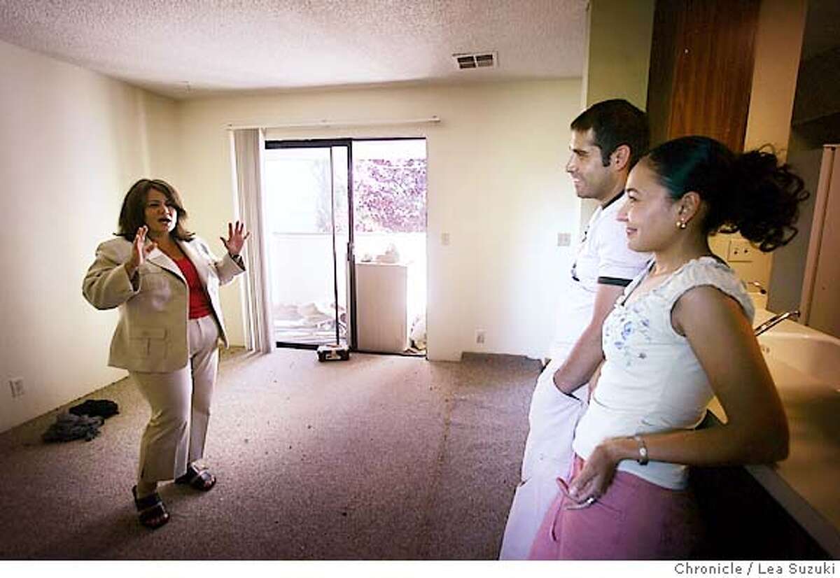 immigrant_mortgage_079_ls.JPG From left: Rebecca Gallardo-Serrano(realtor) , Ramiro and Marisol talk with each other at 312 Stonegate Circle in San Jose on Sunday June 4, 2006. Photo by LEA SUZUKI/The San Francisco Chronicle Photo taken on 6/4/06, in San Jose, CA, USA **cq