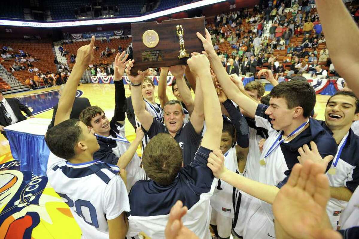 The Immaculate Mustangs celebrate their 67-53 Class S state championship win over Capital Prep at Mohegan Sun Arena in Uncasville on Saturday, March 17, 2012.