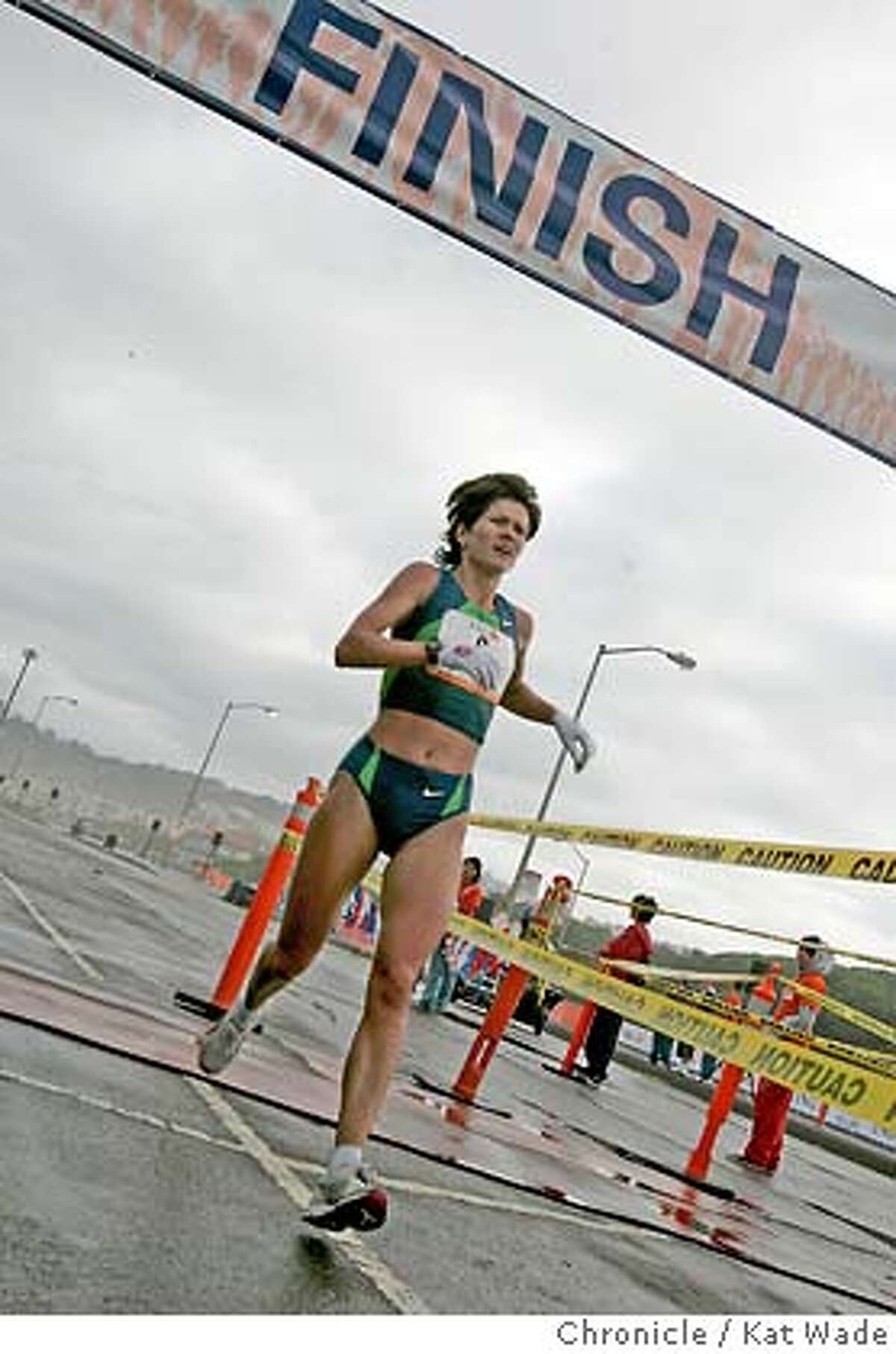 The defending champion, Tetyana Hladyr, 31, from the Ukraine is the first female across the finish line on the Great Highway at Ocean Beach about 35 minutes after the start of the 95th Annual Bay to Breakers race Sunday May 21, 2006. (Kat Wade/The Chronicle) ** Tetyana Hladyr cq