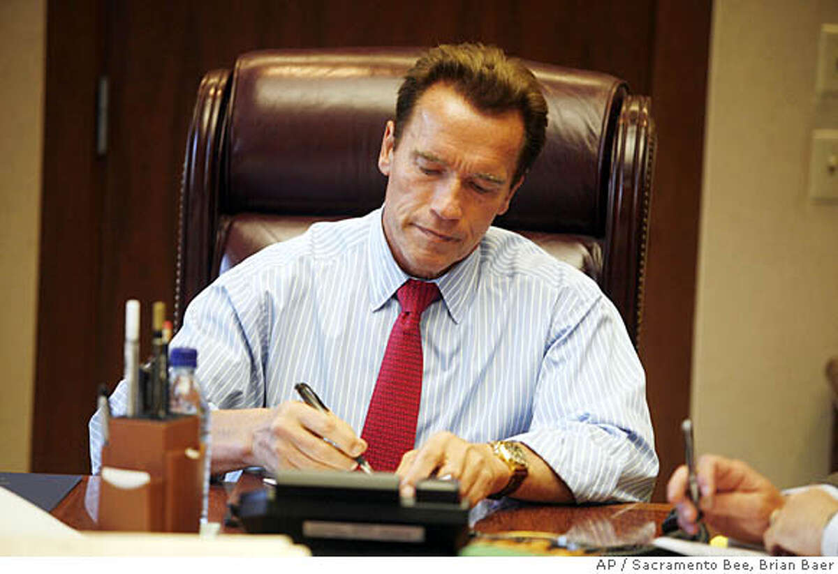 California Gov. Arnold Schwarzenegger signs new bills into law in the Ronald Reagan Cabinet room, Monday Oct. 8, 2007, in Sacramento, Calif. (AP Photo/Sacramento Bee, Brian Baer) ** NO MAGS, NO SALES, NO TV, NO INTERNET **