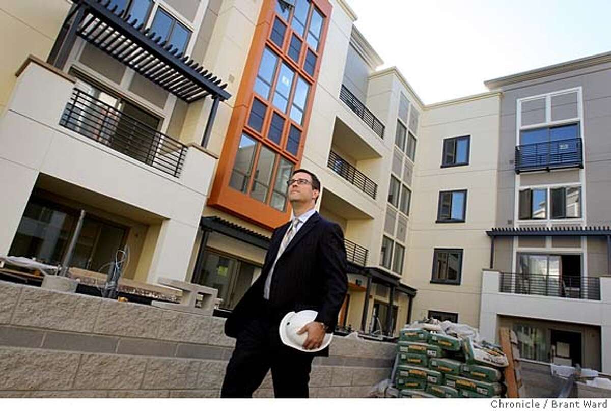 UPTOWN_211.JPG Signature Properties Mike Ghielmetti (chk spell) takes a walk through the courtyard of his Broadway Grand development. Jerry Brown's dream of 10,000 new Oakland residents is embodied in the Uptown District of Oakland, bounded by 18th to 22nd streets and Broadway and Telegraph Avenues. Construction is roaring along on some of the most ambitious condo-retail projects. {By Brant Ward/San Francisco Chronicle}9/18/07