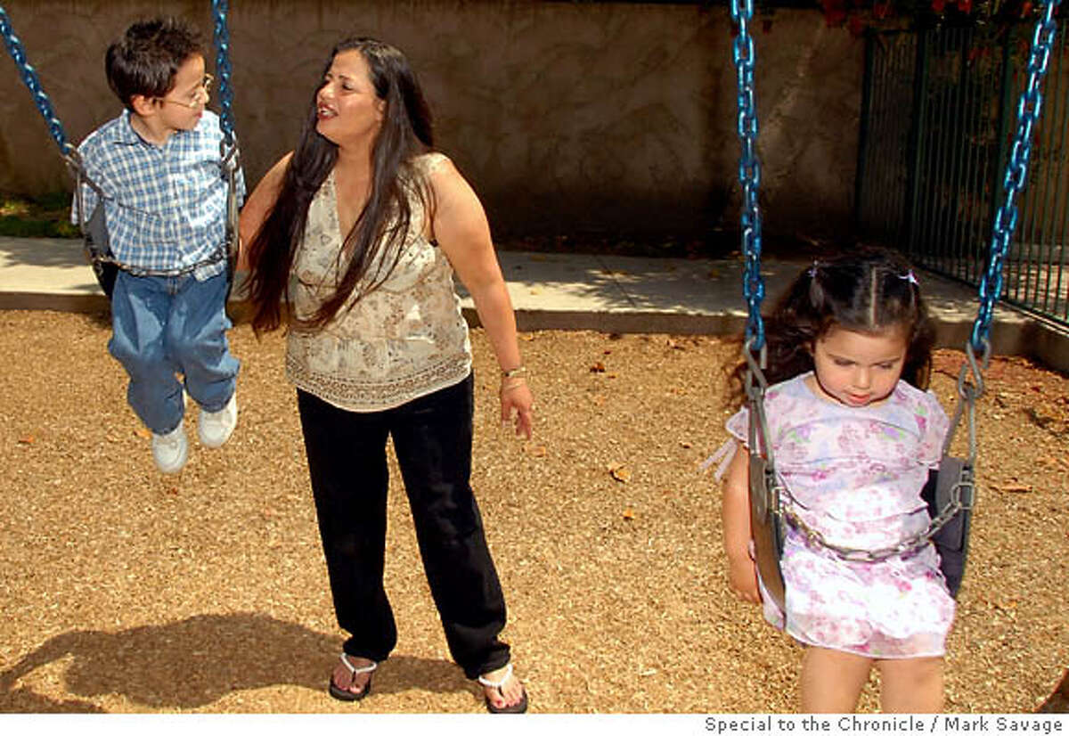Slug: PRISONMOMS Created by: Vicki Haddock 5/10/2006 Juanita Massie, mother of Louie, age 4, and Evangelina, age 2, play in the children's playground at Walden House, a half-way house in El Monte, CA. Mark Savage Photography Advertising, Public Relations, Editorial 310-367-4706 www.MarkSavage.com www.SoulsAndPassions.com
