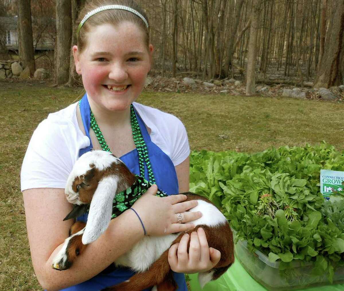 Anna Kimberly with a baby goat, Ada Oklahoma, from Butterfield Farm of East Granby on Saturday at Norfield Grange's Winter Farmers Market.
