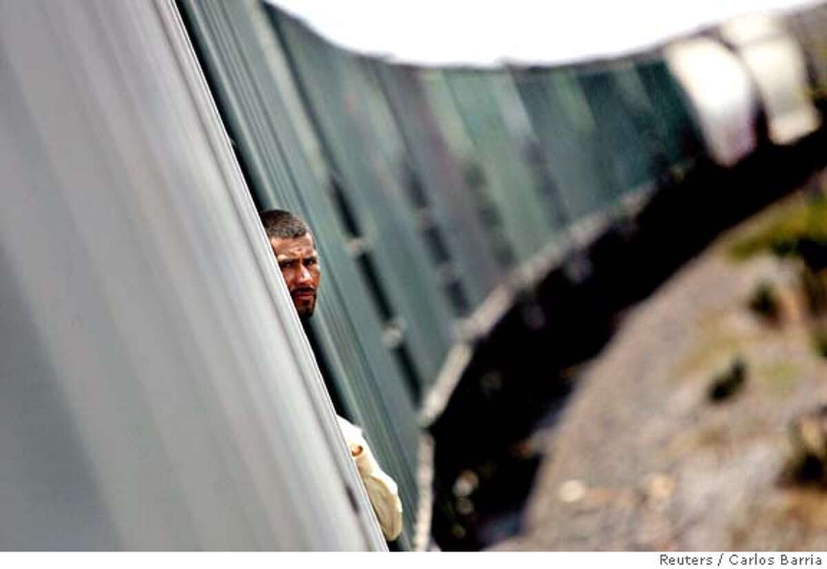Luis Gomez of Honduras travels on a cargo train to border city of Nuevo Laredo