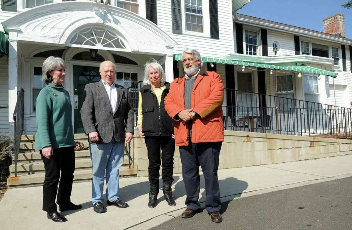 Area preservationists pose for a photo outside the Sterling Farms farmhouse which they recently fought to save from demolition. From left are Cynthia Reeder, Marshall Millsap, Renee Kahn, and William Bretchger. Millsap and Bretchger are members of the Old Long Ridge Historic District Commission. Kahn and Reeder are members of the Historic Neighborhood Preservation Program.