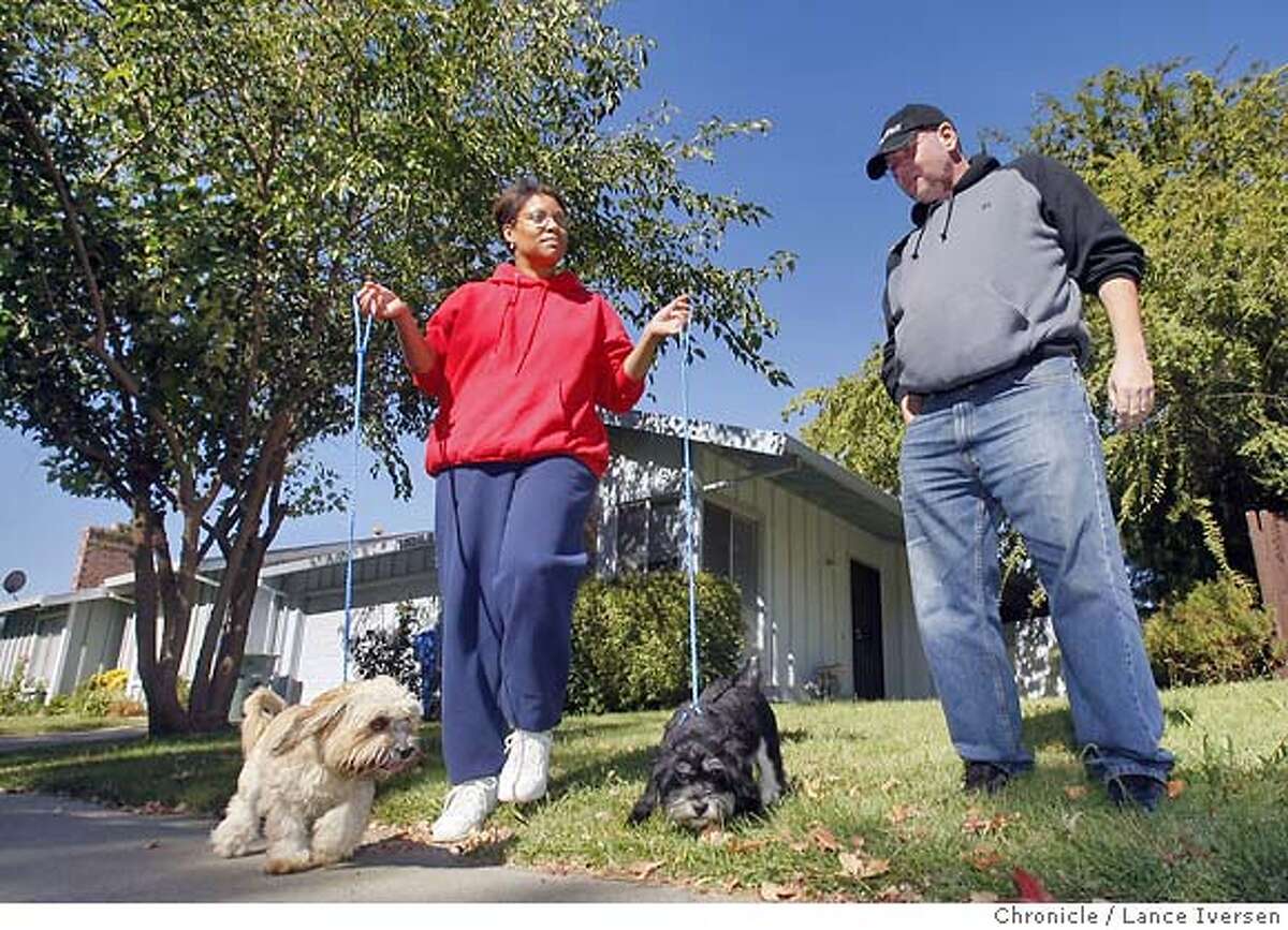 LOANMOD09_72923.JPG Susan and Paul and Howard of Sacramento walk their dogs Chipper and Chopper in front of their home. The Howard's are feeling pinched by rising interest on adjustable mortgages. Paul has been trying unsuccessfully to get Litton Loan to modify his ARM. It went up $550 a month in April/May and is slated to go up again in December and every six months thereafter. Howard is one of the lucky one; his loan company has pledged to work with him freezing his current loan for at least six months. OCTOBER 06, 2007. Lance Iversen/The Chronicle (cq) SUBJECT 10/06/07,in SACRAMENTO. CA.