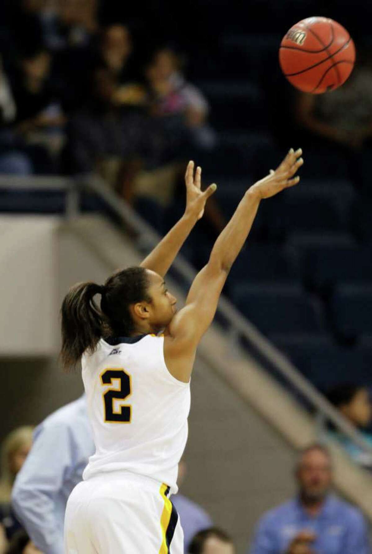 West Virginia guard Taylor Palmer (2) launches a three-point shot during a first-round NCAA tournament women's college basketball game against Texas in Norfolk, Va., Saturday, March 17, 2012. West Virginia won 68-55. (AP Photo/Steve Helber)