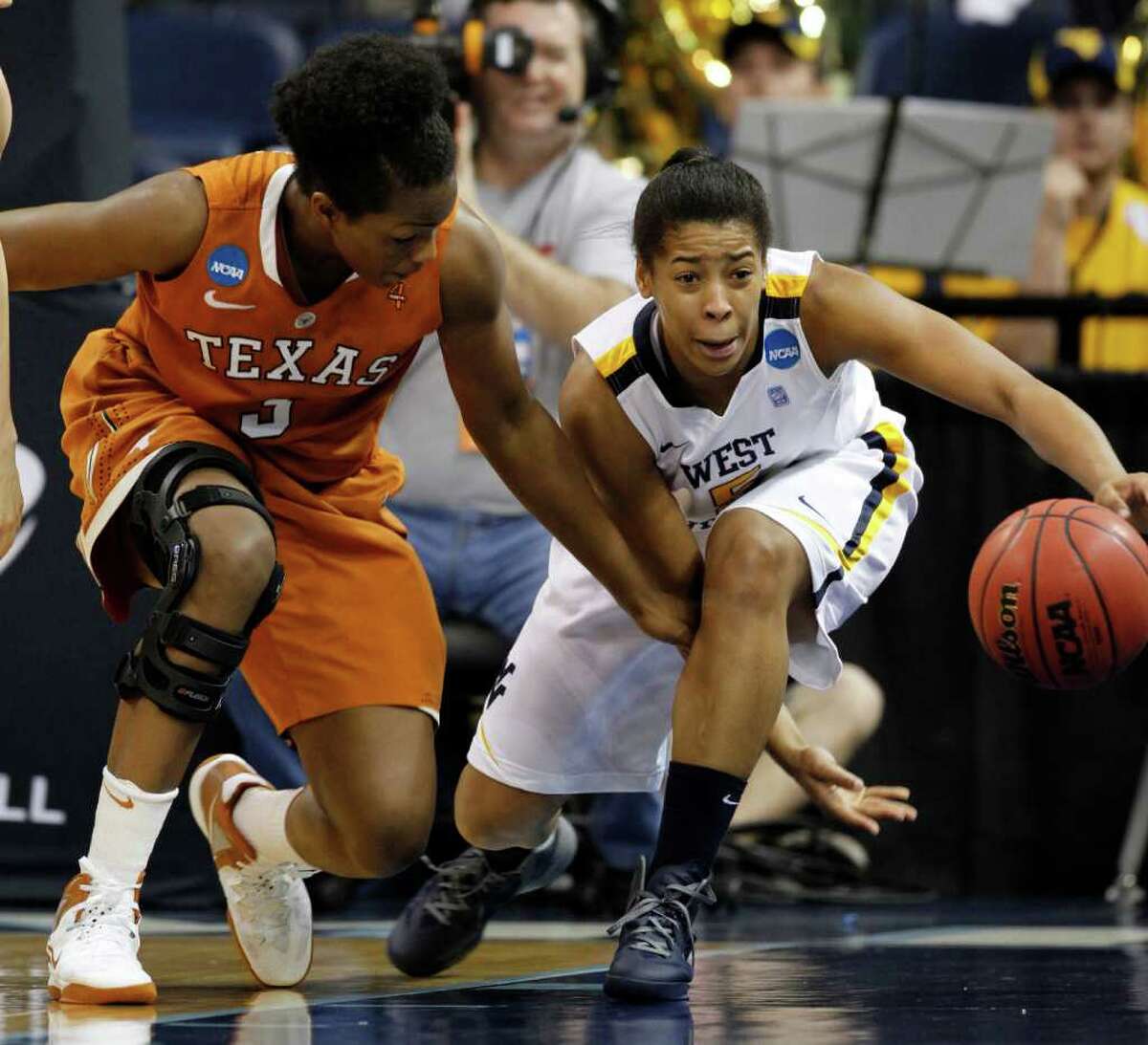 Texas forward Nneka Enemkpali (3) tries to get steal the ball from West Virginia forward Averee Fields (5) during the first half of a first-round NCAA tournament women's college basketball game in Norfolk, Va., Saturday, March 17, 2012. (AP Photo/Steve Helber)