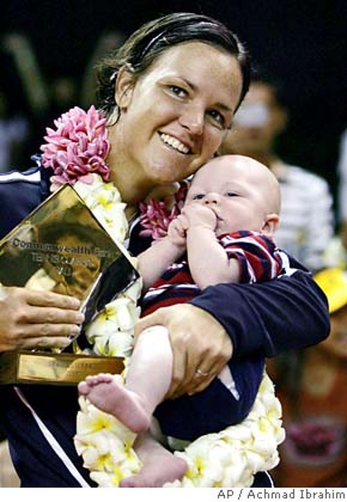 Lindsay Davenport of the USA holds her baby Jagger Jonathan Leach, 3 , after her victory over Daniela Hantuchova of sovlakia during a final match of the WTA Bali Open tennis tournament in Nusa Dua, Bali, Indonesia, Sunday, Sept 16, 2007. Davenport won 6-4,3-6, 6-2. (AP Photo/Achmad Ibrahim)