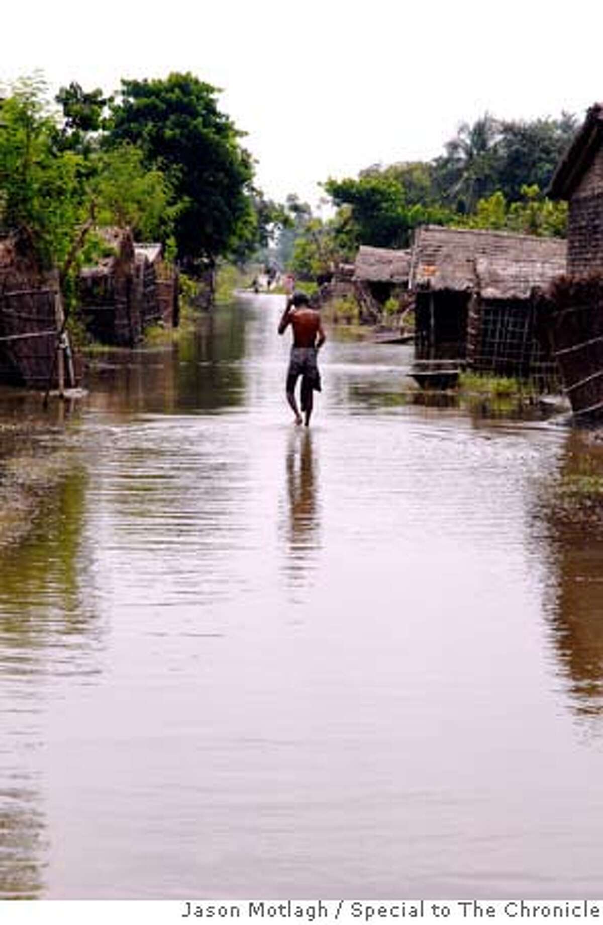 A man belonging to the musafar, the lowest sub-caste in Indian society, wades through water back to village in Muzaffarpur district. CR: Jason MOTLAGH / Special to The Chronicle