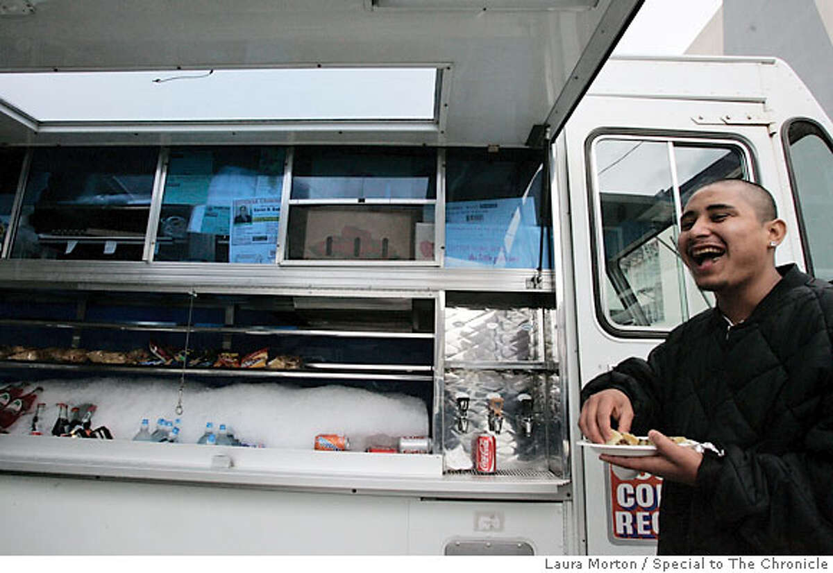 BARGAIN04_0072_LKM.jpg Jorge Sandoval laughs with his friends while eating lunch from the El Norteno taco truck. The truck caters to the lunchtime crowd and is parked in a lot off Bryant St. between 6th and 7th streets in San Francisco. (Laura Morton/Special to the Chronicle) *** Jorge Sandoval