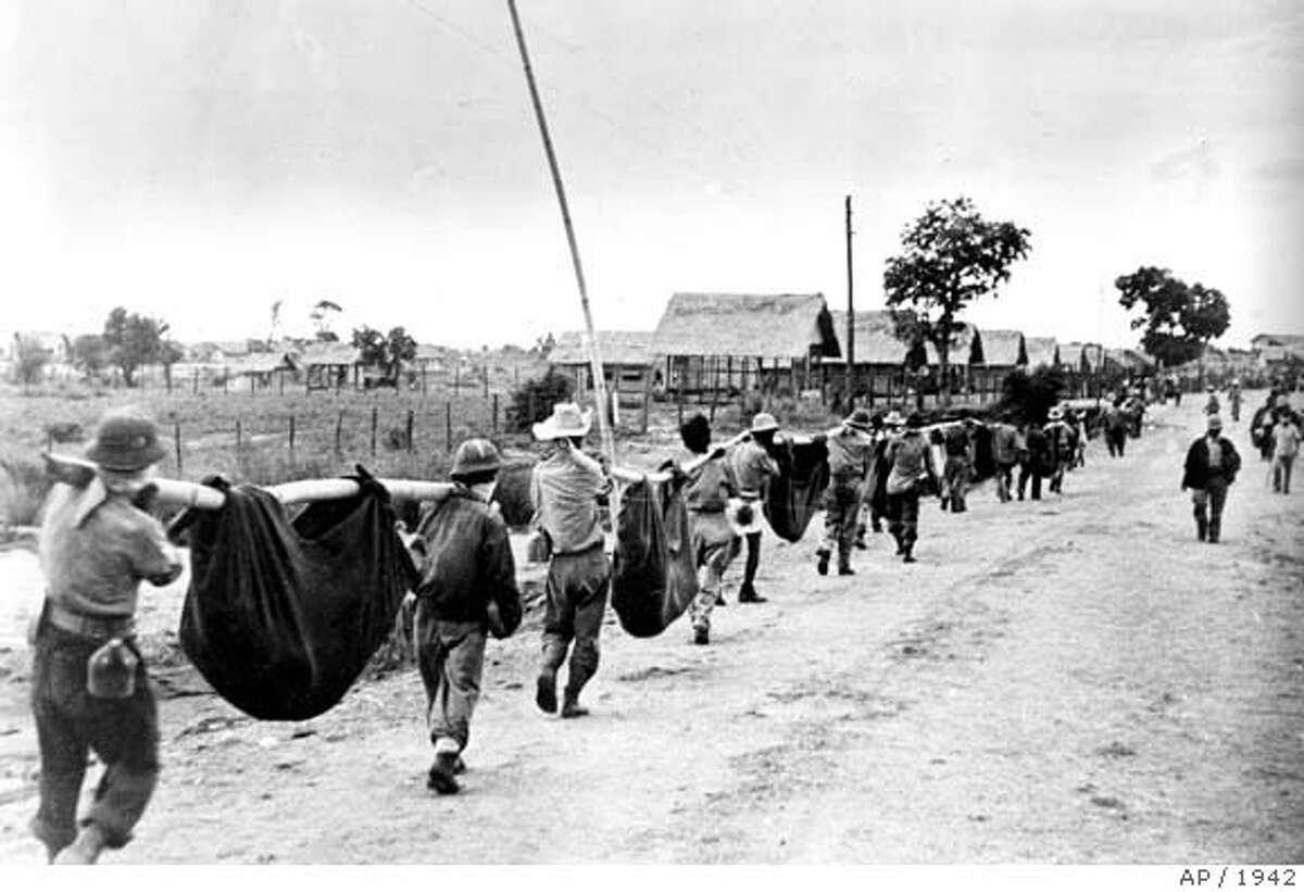 ** ADVANCE FOR SUNDAY, FEB. 25 ** FILE ** Nearing the end of the Bataan Death March, a thinning line of American and Filipino prisoners of war carry casualties in improvised stretchers as they approach Camp O'Donnell, a new Japanese POW camp, in April 1942 during World War II. Newly declassified CIA records, released by the U.S. National Archives and examined by The Associated Press, document more fully than ever how suspected Japanese war criminals were recruited by U.S. intelligence in the early days of the Cold War. (AP Photo) Ran on: 02-25-2007 Maj. Gen. Charles Willoughby, chief of G-2 in the occupation government. HFR 02-25-07 ADVANCE FOR SUNDAY, FEB. 25 - APRIL 1942 FILE PHOTO