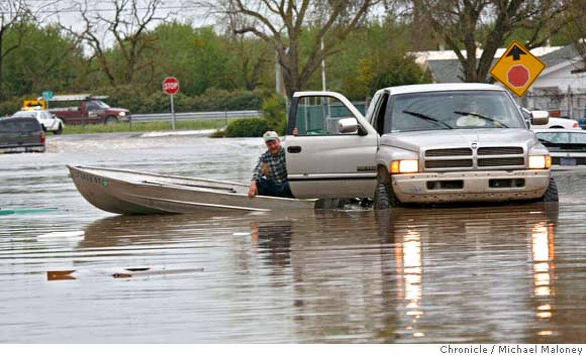 Levees break, flooding farmland and a trailer park