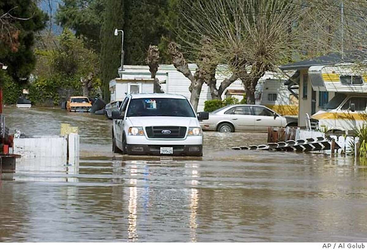 Levees break, flooding farmland and a trailer park