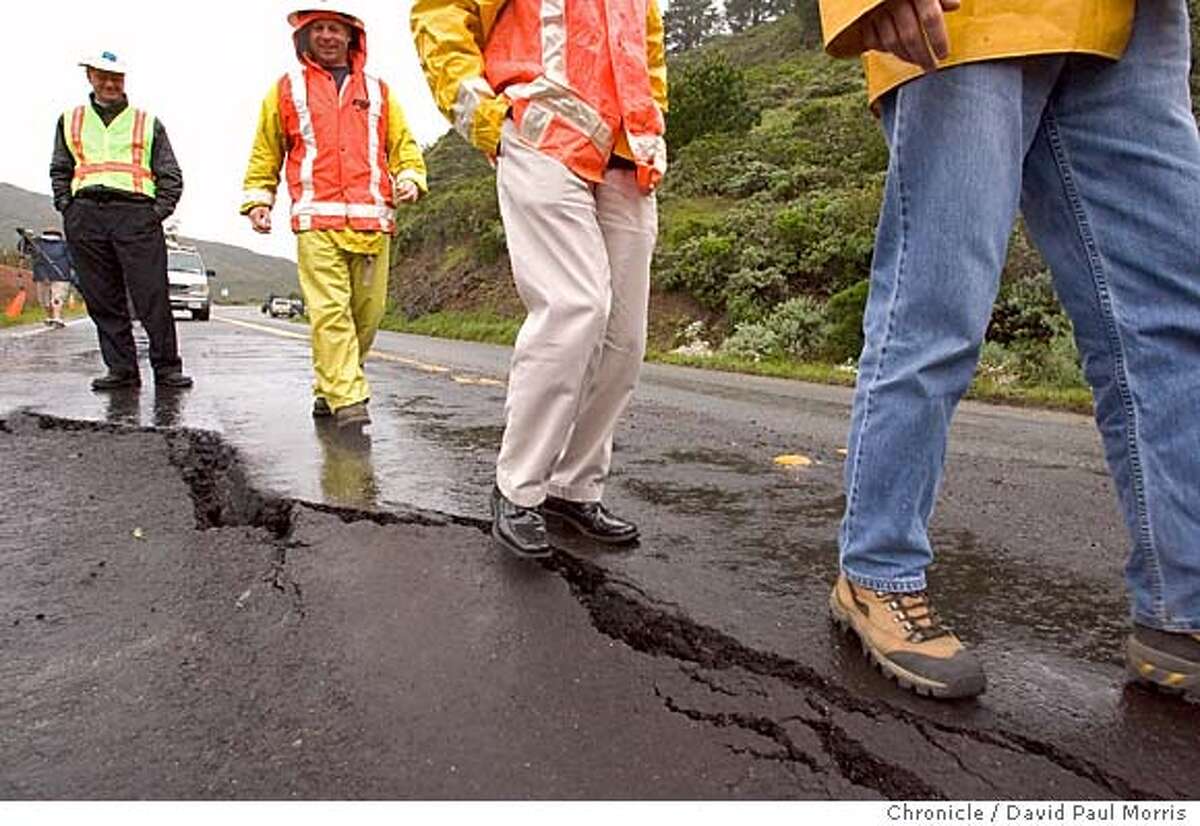 PACIFICA, CALIFORNIA - April 3, 2006 : Cal Trans workers look over a mud slide along Highway 1 at the Devils Slide area on April 3, 2006 in Pacifica, California . Photo by David Paul Morris